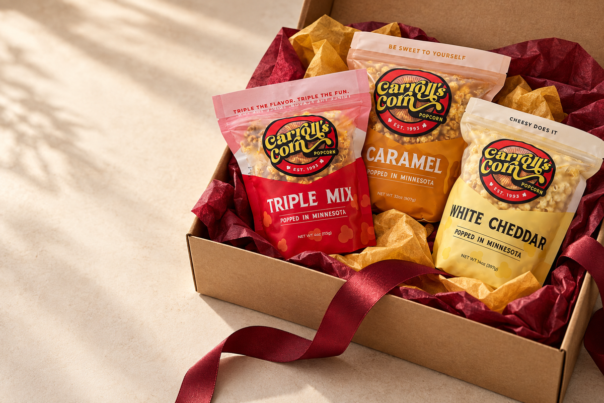 Carroll’s Corn popcorn bags arranged with burgundy and gold gift tissue